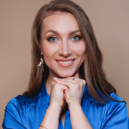 Close portrait of soprano Annija Adamsone in a blue dress