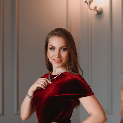 Portrait of soprano Annija Adamsone in a red dress