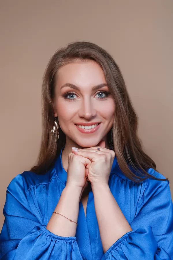 Close portrait of soprano Annija Adamsone in a blue dress
